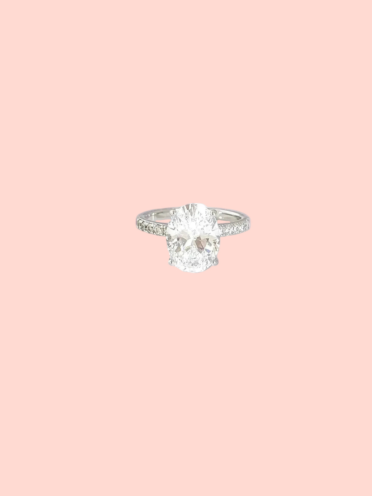 Oval solitaire ring with a statement center stone and pavé details in high quality hand-set CZ, White Gold finish, Size 7