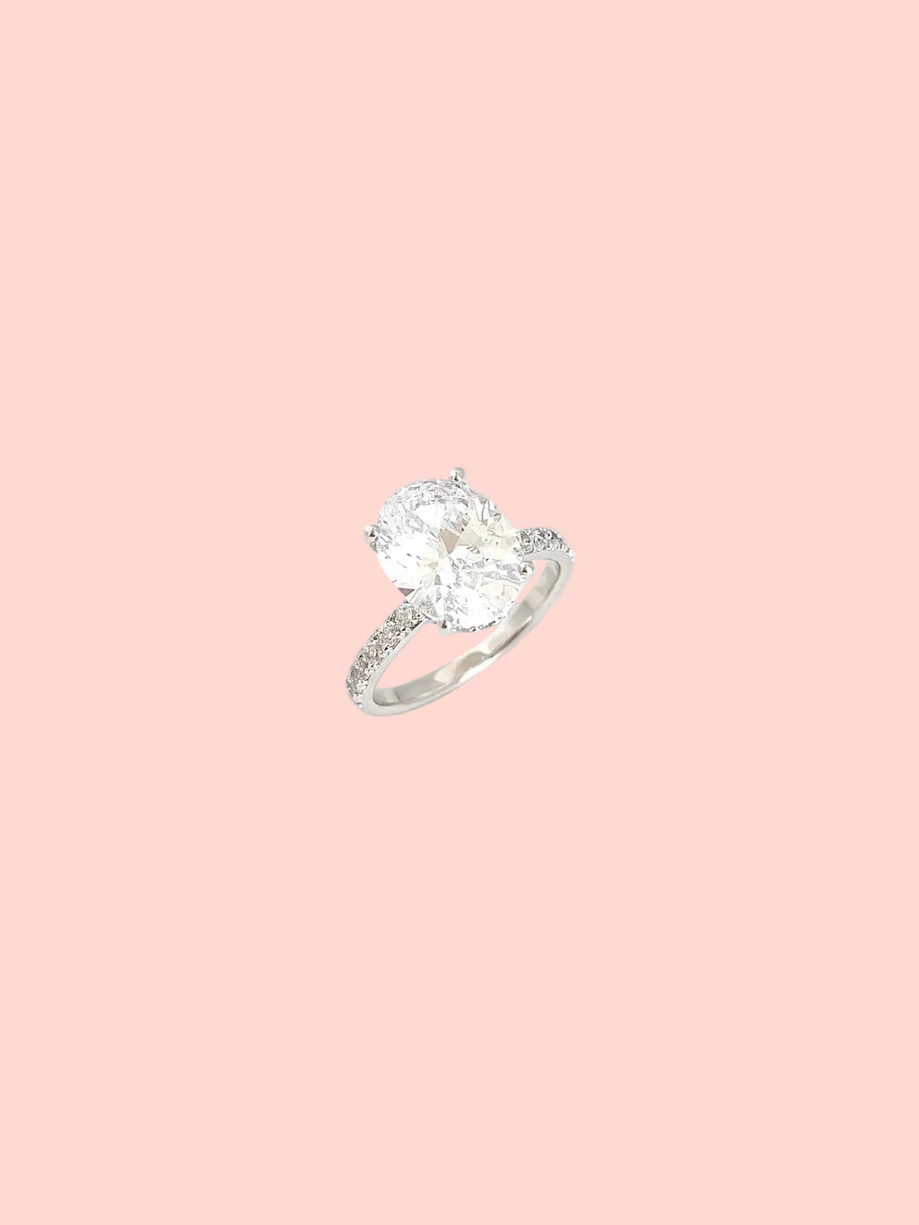 Oval solitaire ring with a statement center stone and pavé details in high quality hand-set CZ, White Gold finish, Size 7