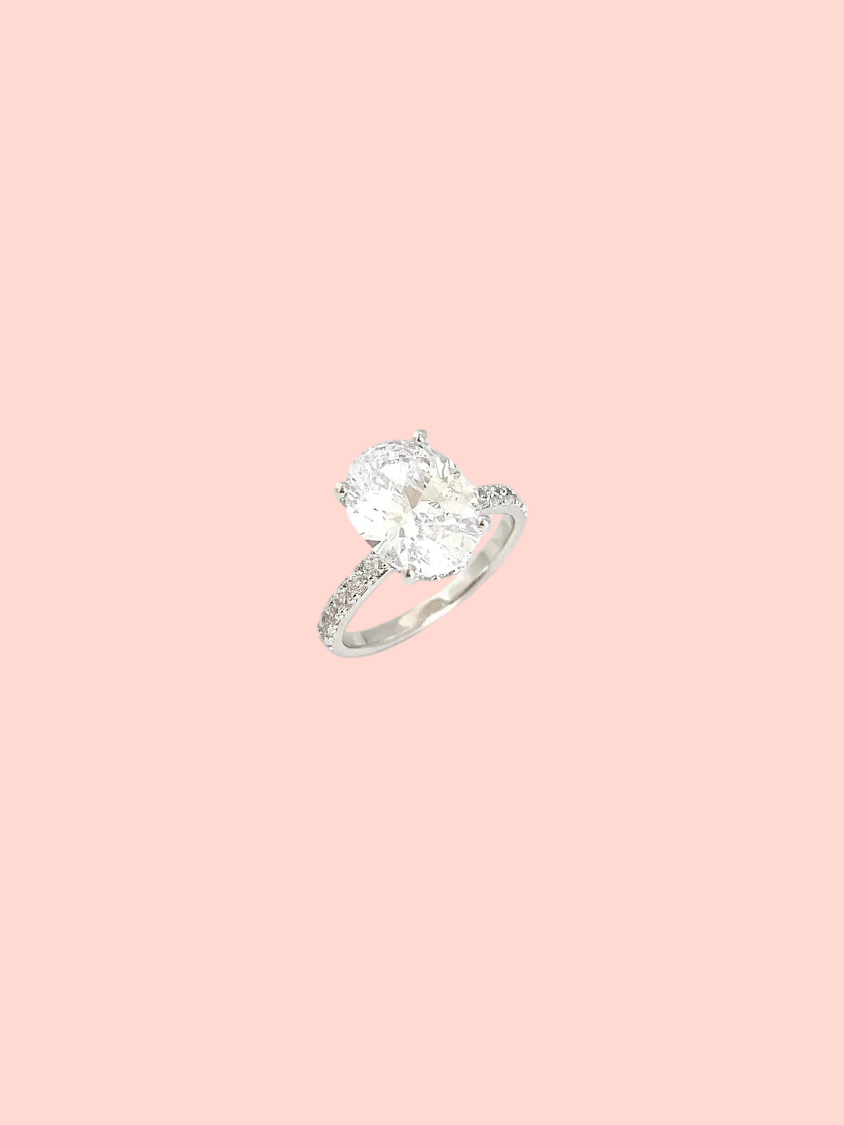 Oval solitaire ring with a statement center stone and pavé details in high quality hand-set CZ, White Gold finish, Size 7